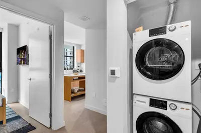 a laundry room with a washer and dryer at 2BR Corner Suite MIA Wrap Balcony Rooftop Pool in Miami