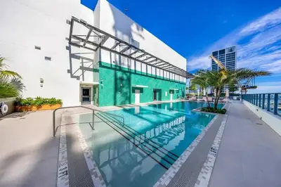 a swimming pool on the side of a building at 2BR Corner Suite MIA Wrap Balcony Rooftop Pool in Miami