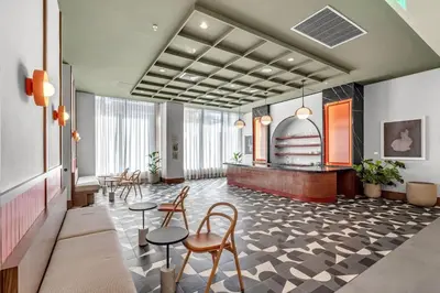 a lobby with chairs and tables in a building at 2BR Corner Suite MIA Wrap Balcony Rooftop Pool in Miami