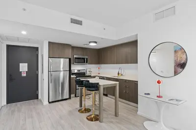 a kitchen with a table and chairs and a refrigerator at The Downtown Miami 2BR 2BA Luxury Stay in Miami