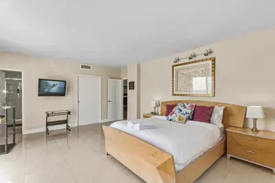 a bedroom with a large bed in a room at Oceanfront Condo with Direct Beach Access in Hollywood Beach