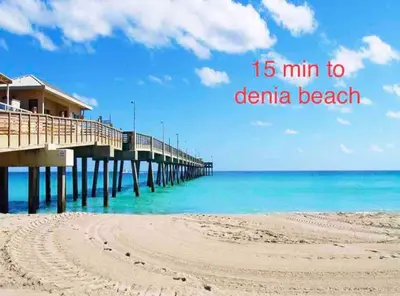 a pier on the beach with the words min to dearna beach at Waterfront ocean House Hollywood Hard Rock airport in Fort Lauderdale
