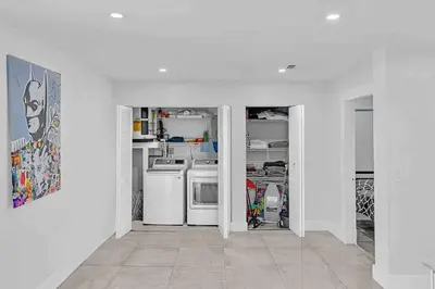 a white kitchen with a stove and a dishwasher at Waterfront ocean House Hollywood Hard Rock airport in Fort Lauderdale
