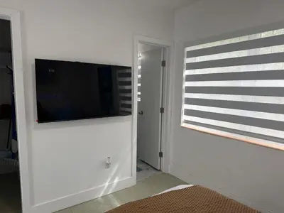 a living room with a flat screen tv on a wall at Villa Clara ROYAL-Little Havana in Miami
