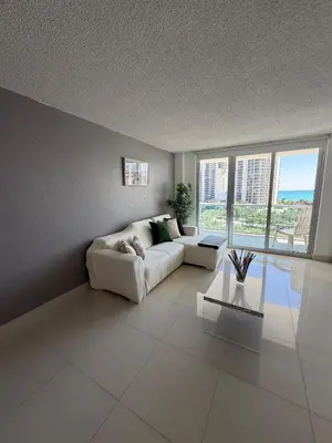 a living room with a couch and a table at Exceptional apartment in Sunny Isles in Sunny Isles Beach