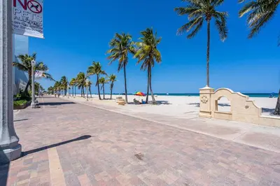 a beach with palm trees and the ocean at Lovely 1 BR Walking Distance To Ocean - Suite 1 in Hollywood
