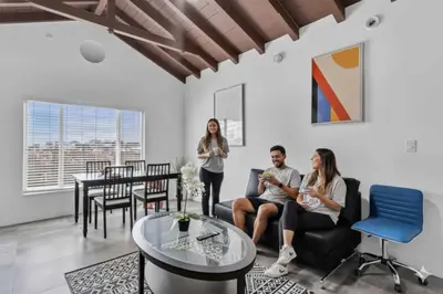 a group of people sitting on a couch in a living room at Lovely 1 BR Walking Distance To Ocean - Suite 1 in Hollywood