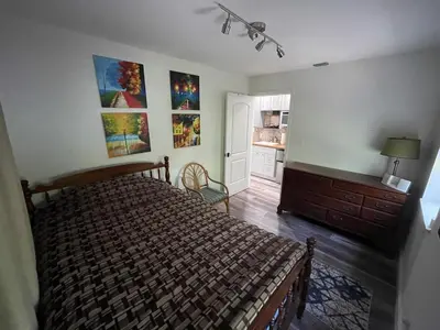 a bedroom with a bed and a dresser at Spanish Style home in Miami Upper East Side in Miami