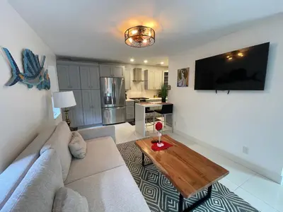 a living room with a couch and a table at Spanish Style home in Miami Upper East Side in Miami