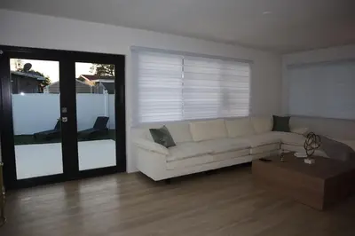 a living room with a white couch and a coffee table at Modern house with pool close to HARD ROCK in Pembroke Pines