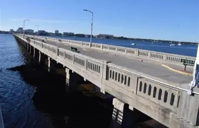 a bridge over a body of water next to the water at My Help Comes from The Lord Miami in Palmetto Bay