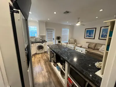 a kitchen and living room with a washer and dryer at Beachside One Bedroom Condo with Pool Access in Hollywood