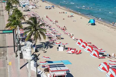 a beach with many umbrellas and people on it at Las Olas Villa in Fort Lauderdale