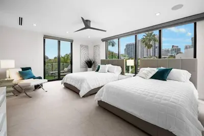 a bedroom with two beds and a large window at Las Olas Villa in Fort Lauderdale