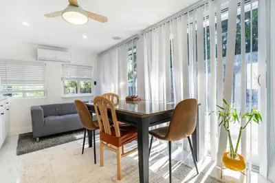 a dining room with a table and chairs at Tropical Retreat- Heated Pool 3 Miles to the Beach in Fort Lauderdale