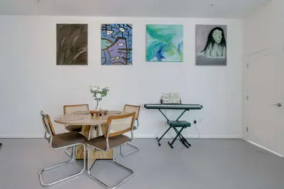 a table and chairs in a room with paintings on the wall at The Vizcayne Vibe- Sauna Pool and Sundeck in Miami