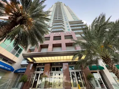 a tall building with palm trees in front of it at The Vizcayne Vibe- Sauna Pool and Sundeck in Miami