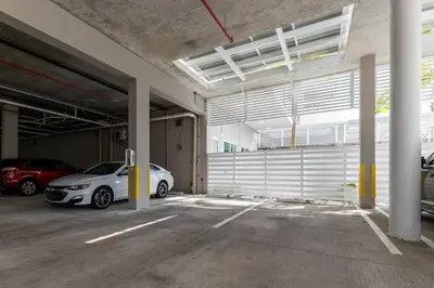 a parking garage with two cars parked in it at Tropical Nest Residence in Hollywood