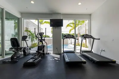 a gym with treadmills and cardio equipment in a room at Tropical Nest Residence in Hollywood