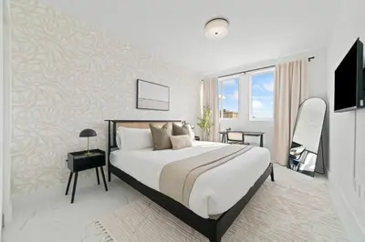 a bedroom with a large bed and a window at Pool & Gym | King Bed | Downtown Hollywood in Hollywood