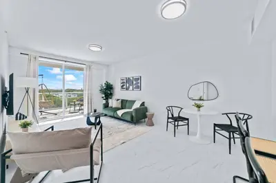 a living room with a couch and a table at Pool & Gym | King Bed | Downtown Hollywood in Hollywood