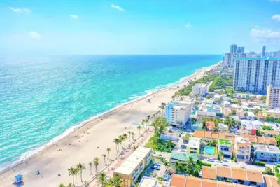 an aerial view of a beach with buildings and the ocean at Pool & Gym | King Bed | Downtown Hollywood in Hollywood