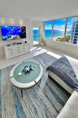 a living room with a couch and a tv at Beach Paradise Awaits No Resort Parking Fees in Hollywood