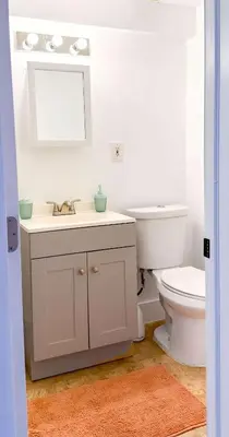 a white bathroom with a sink and a toilet at Take It Easy - Studio Pool Waterfront in Fort Lauderdale