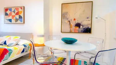 a room with a table and chairs and a bed at Take It Easy - Studio Pool Waterfront in Fort Lauderdale