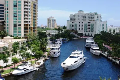 a group of boats docked in a river in a city at Central Fort Lauderdale 2BR Cottage Near Beach in Fort Lauderdale