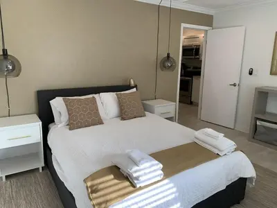 a bedroom with a large bed with towels on it at Central Fort Lauderdale 2BR Cottage Near Beach in Fort Lauderdale
