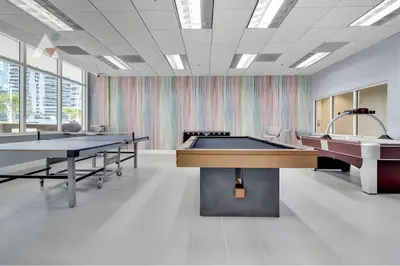 a large room with two ping pong tables at Sky-High Urban Sanctuary with Coastal Glimpses in Miami