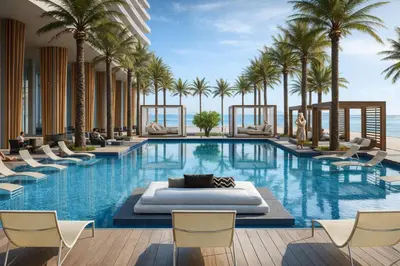 a hotel pool with palm trees and lounge chairs at Beachfront Luxe Condo Sunrise Oceanview Balcony in Hollywood