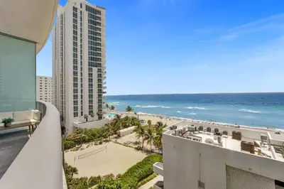 a view of the beach from the balcony of a building at Beachfront Luxe Condo Sunrise Oceanview Balcony in Hollywood