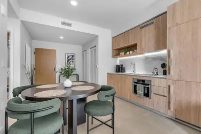 a kitchen with a table and chairs in a room at Modern Chic 1BR Downtown with Rooftop Pool & Views in Miami