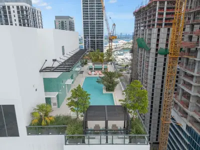 a view of the pool from the balcony of a building at Modern Chic 1BR Downtown with Rooftop Pool & Views in Miami