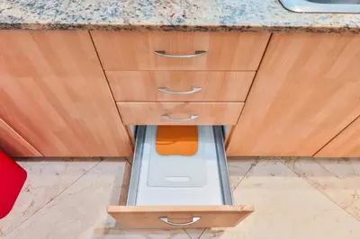 a kitchen with wooden cabinets with a drain under it at Blue Horizon at Sunny Isles King David in Sunny Isles Beach