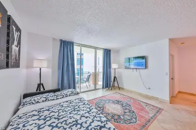 a bedroom with a bed and a large window at Blue Horizon at Sunny Isles King David in Sunny Isles Beach