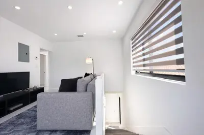 a living room with a chair and a television at Luxury 1 King BR Retreat near Calle Ocho in Miami