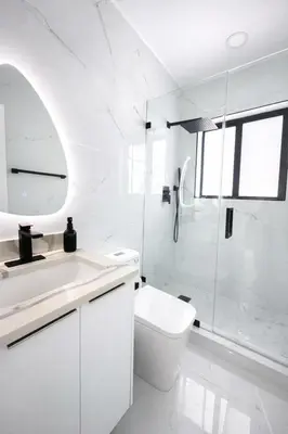 a white bathroom with a toilet and a shower at Luxury 1 King BR Retreat near Calle Ocho in Miami