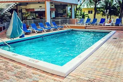 a large swimming pool with chairs at 2 BR-11th Floor Corner Unit - Fort Lauderdale Beach Resort in Fort Lauderdale