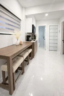 a kitchen with a wooden table and chairs at Luxury 2BR Miami Retreat King Suite Free Parking in Miami