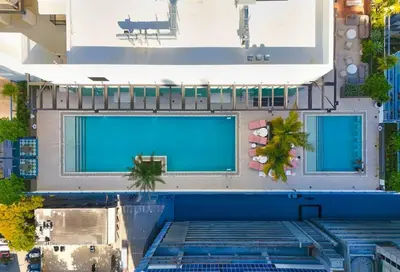 an overhead view of a building with two swimming pools at MIA Worldcenter Premium 1BR Balcony & Rooftop Pool in Miami