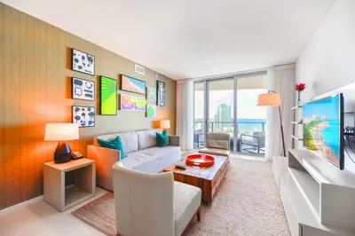 a living room with a couch and a table at Ocean Views Plus Beachside & Roofpool in Hollywood