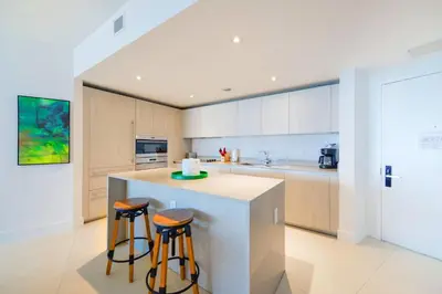 a kitchen with a counter and two stools at Ocean Views Plus Beachside & Roofpool in Hollywood