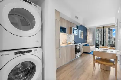 a kitchen and a living room with a washing machine at City-View Condo W Pool Access & Free Parking in Miami