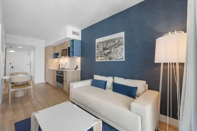 a living room with a couch and a kitchen at City-View Condo W Pool Access & Free Parking in Miami