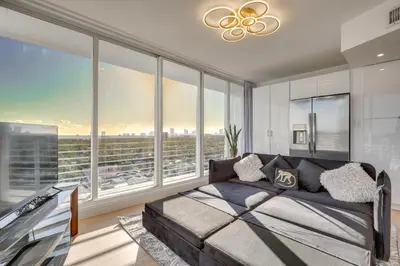 a bedroom with a large bed and large windows at Elegant Condo with Stunning Views in Dtwn Hollywood in Hollywood