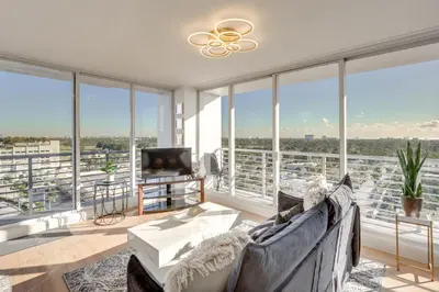 a living room with a couch and large windows at Elegant Condo with Stunning Views in Dtwn Hollywood in Hollywood