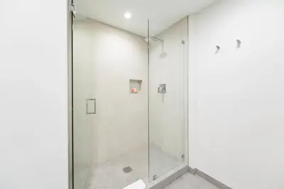 a shower with a glass door in a bathroom at Ocean View Stay with Rooftop Pool Near the Beach in Hollywood